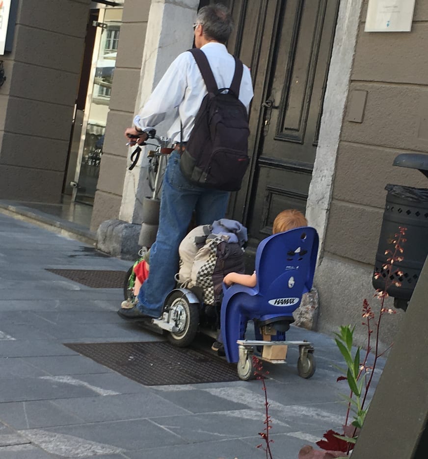Love the homemade scooter this man made to transport his children. One toddler in front and one behind – what a great idea.  I wish now I had got up and taken a better picture rather than after he had gone past.